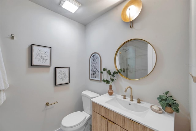 bathroom with toilet, vanity, and a shower