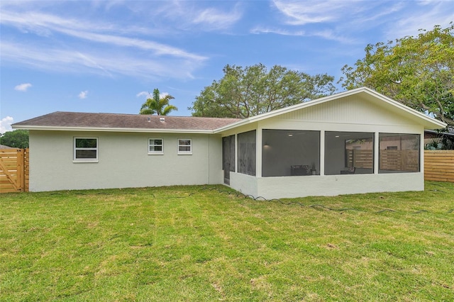 rear view of property featuring a sunroom and stucco siding