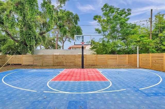 view of basketball court featuring basketball court and a fenced backyard