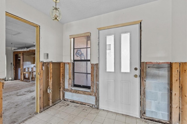 4274 Deleon Dr, Hernando Beach, FL 34607 - entryway with a textured ceiling and light tile patterned floors