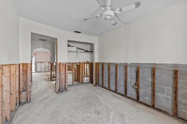 4274 Deleon Dr, Hernando Beach, FL 34607 - unfurnished room with ceiling fan, arched walkways, and a textured ceiling
