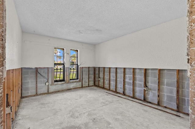 4274 Deleon Dr, Hernando Beach, FL 34607 - unfurnished room featuring a textured ceiling and unfinished concrete flooring