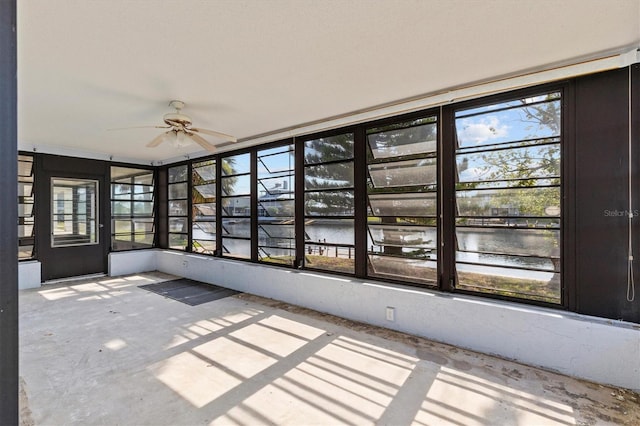 4274 Deleon Dr, Hernando Beach, FL 34607 - unfurnished sunroom with a water view, a ceiling fan, and plenty of natural light