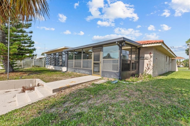 4274 Deleon Dr, Hernando Beach, FL 34607 - back of house featuring a sunroom and stucco siding
