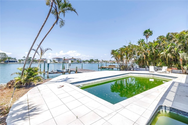 31 Dolphin Dr, Treasure Island, FL 33706 - outdoor pool with boat lift, a dock, and a water view