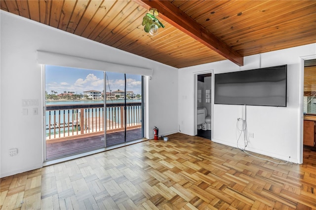 31 Dolphin Dr, Treasure Island, FL 33706 - unfurnished living room featuring beam ceiling, wooden ceiling, and baseboards
