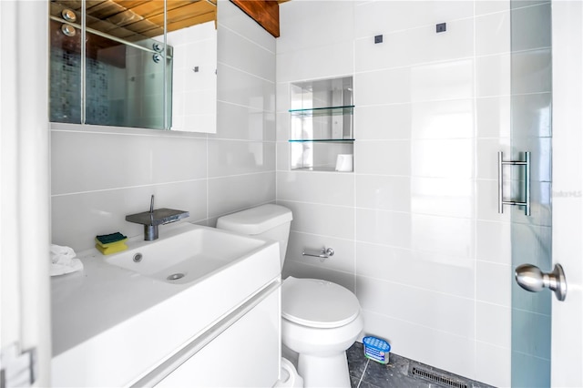 31 Dolphin Dr, Treasure Island, FL 33706 - bathroom with tile walls, toilet, vanity, and a tile shower
