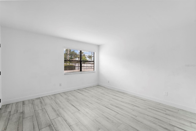 3102 W Horatio St Unit 13, Tampa, FL 33609 - spare room featuring wood finished floors and baseboards