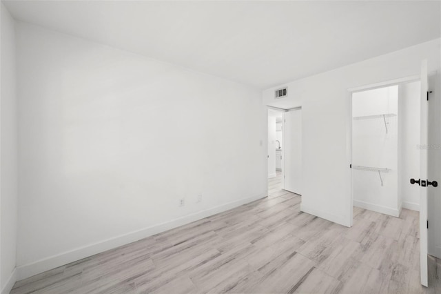 3102 W Horatio St Unit 13, Tampa, FL 33609 - unfurnished bedroom featuring a closet, wood finished floors, and baseboards