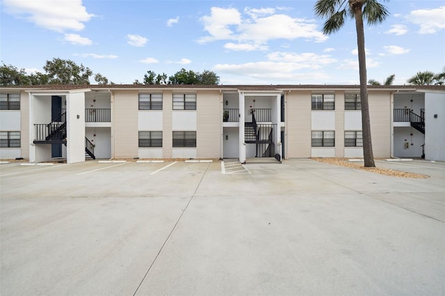 3102 W Horatio St Unit 13, Tampa, FL 33609 - view of building exterior featuring stairs and uncovered parking