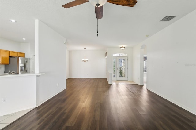 3311 Stonebridge Trl, Valrico, FL 33596 - unfurnished living room with dark wood-type flooring, a ceiling fan, baseboards, arched walkways, and recessed lighting