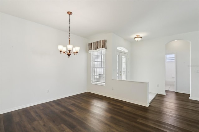3311 Stonebridge Trl, Valrico, FL 33596 - unfurnished room featuring arched walkways, dark wood-style flooring, a chandelier, and baseboards