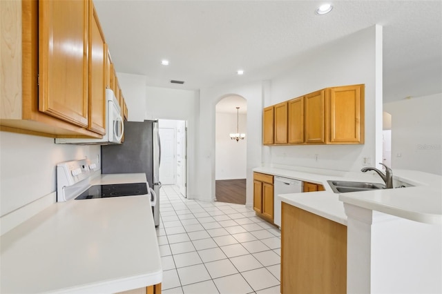 3311 Stonebridge Trl, Valrico, FL 33596 - kitchen featuring a sink, white appliances, a peninsula, light countertops, and arched walkways