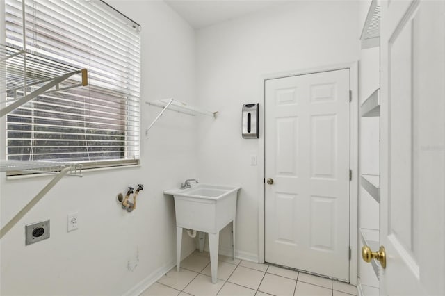 3311 Stonebridge Trl, Valrico, FL 33596 - laundry area with hookup for an electric dryer, light tile patterned flooring, and baseboards