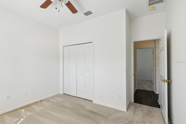 3311 Stonebridge Trl, Valrico, FL 33596 - unfurnished bedroom featuring light colored carpet, baseboards, a closet, and a ceiling fan