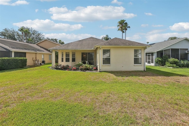 3311 Stonebridge Trl, Valrico, FL 33596 - rear view of house with stucco siding and a lawn