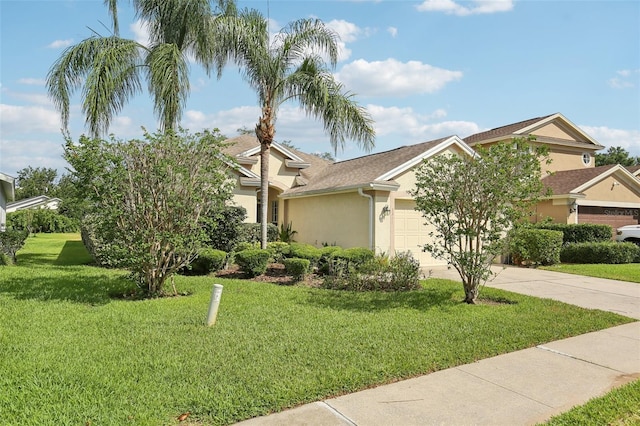 3311 Stonebridge Trl, Valrico, FL 33596 - obstructed view of property featuring stucco siding, a garage, driveway, and a front lawn