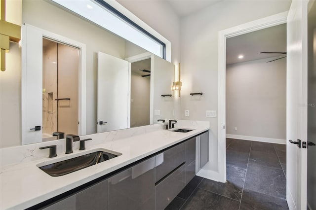 full bathroom featuring double vanity and baseboards