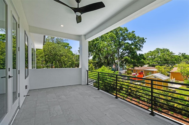 view of patio / terrace featuring a ceiling fan and a balcony