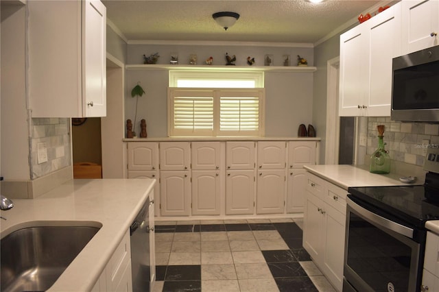 9639 Mainlands Blvd E, Pinellas Park, FL 33782 - kitchen with appliances with stainless steel finishes, white cabinets, backsplash, light countertops, and a sink