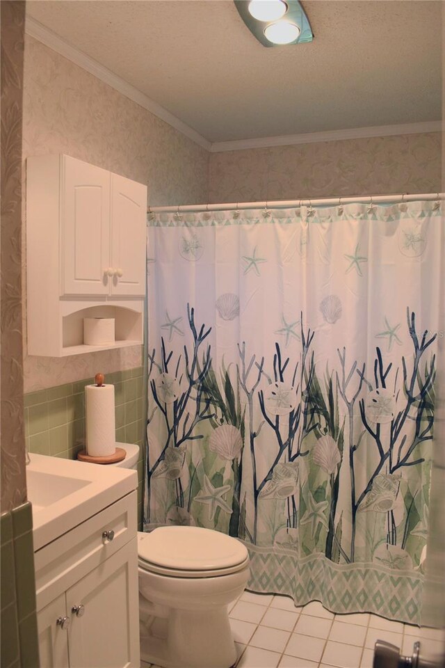 9639 Mainlands Blvd E, Pinellas Park, FL 33782 - bathroom featuring tile walls, tile patterned floors, toilet, wallpapered walls, and vanity