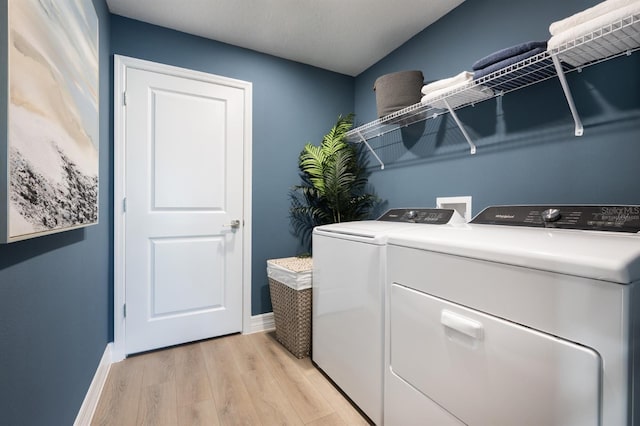 6236 SW 95th Pl, Ocala, FL 34476 - laundry area with washer and clothes dryer, light wood-style floors, and baseboards