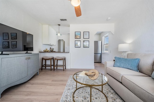13304 2nd St E, Madeira Beach, FL 33708 - living room featuring a ceiling fan and light wood finished floors