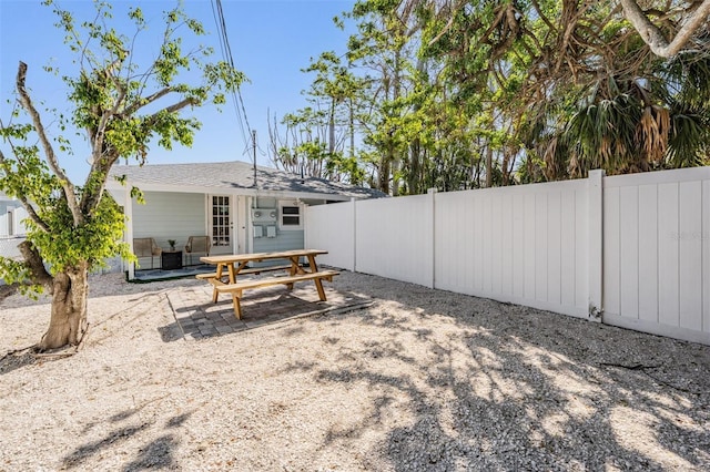 13304 2nd St E, Madeira Beach, FL 33708 - rear view of property with a fenced backyard, a patio area, and outdoor dining space
