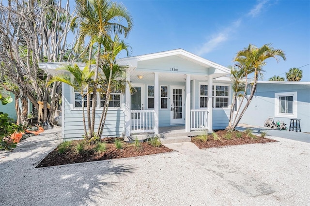 13304 2nd St E, Madeira Beach, FL 33708 - view of front facade featuring a porch