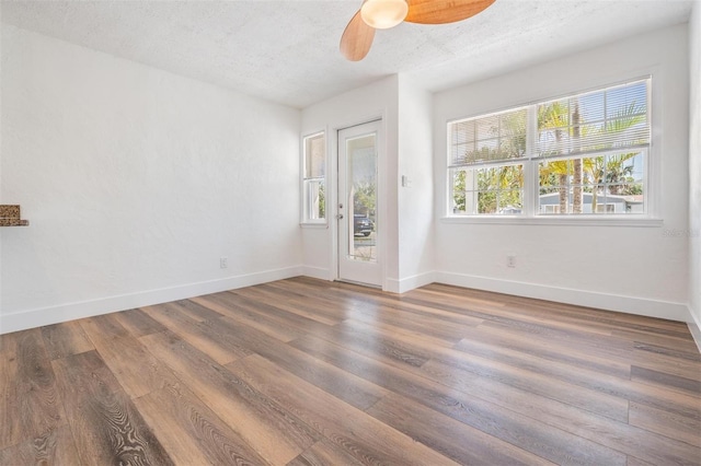 13304 2nd St E, Madeira Beach, FL 33708 - unfurnished room featuring a ceiling fan, wood finished floors, baseboards, and a textured ceiling