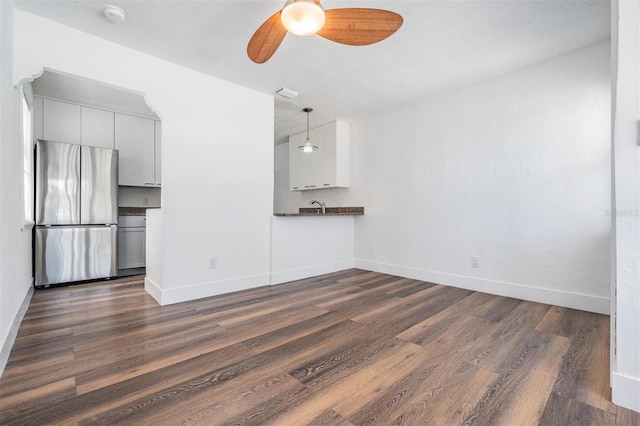 13304 2nd St E, Madeira Beach, FL 33708 - unfurnished living room with dark wood-style floors, ceiling fan, baseboards, and a sink