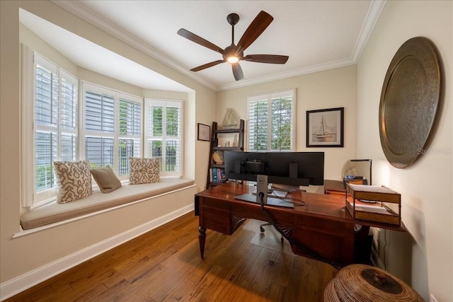 office area with baseboards, wood finished floors, a ceiling fan, plenty of natural light, and crown molding