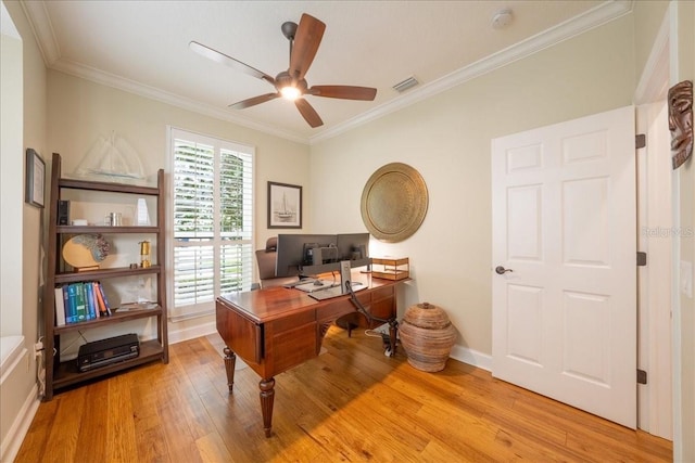 home office featuring light wood-style flooring, crown molding, a ceiling fan, and baseboards