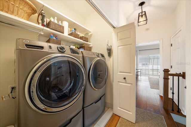 washroom featuring separate washer and dryer and wood finished floors