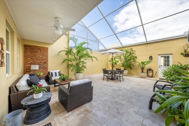 view of patio / terrace featuring a ceiling fan, outdoor dining area, outdoor lounge area, and glass enclosure