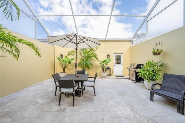 view of patio featuring outdoor dining area, a lanai, and grilling area