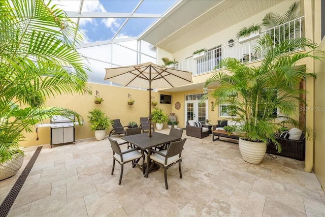view of patio featuring french doors, a balcony, outdoor lounge area, outdoor dining space, and glass enclosure