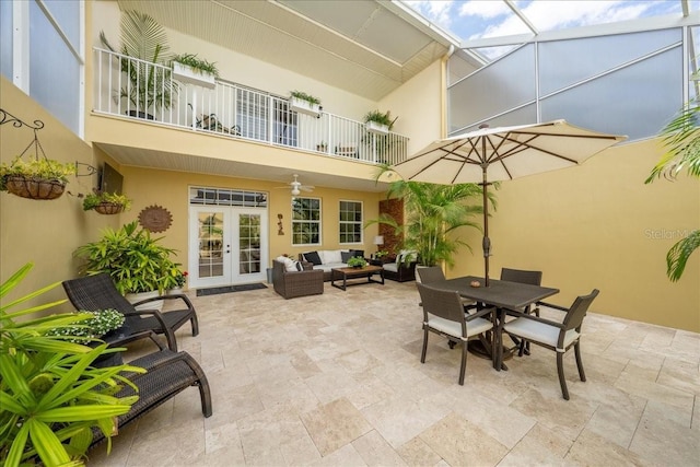 view of patio featuring french doors, a balcony, an outdoor hangout area, a ceiling fan, and outdoor dining space