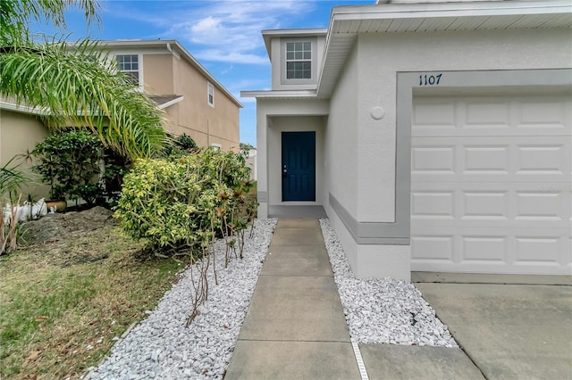 1107 Seminole Sky Dr, Ruskin, FL 33570 - view of exterior entry featuring stucco siding