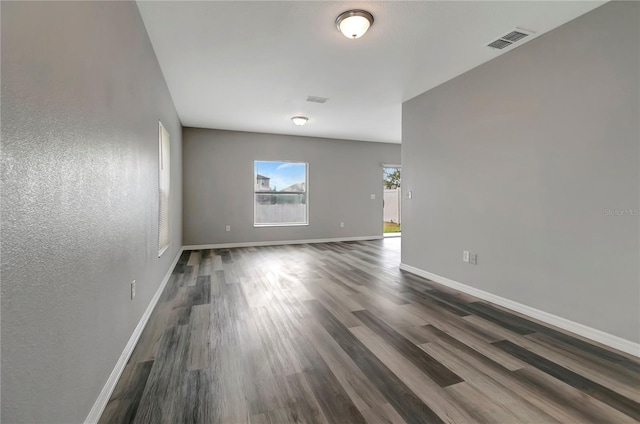 1107 Seminole Sky Dr, Ruskin, FL 33570 - unfurnished room with dark wood-style floors, baseboards, and a textured wall
