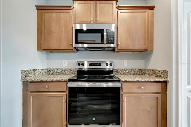 1107 Seminole Sky Dr, Ruskin, FL 33570 - kitchen with stainless steel appliances, light brown cabinetry, and light stone counters