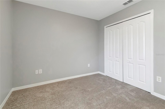 1107 Seminole Sky Dr, Ruskin, FL 33570 - unfurnished bedroom with carpet floors, baseboards, and a closet