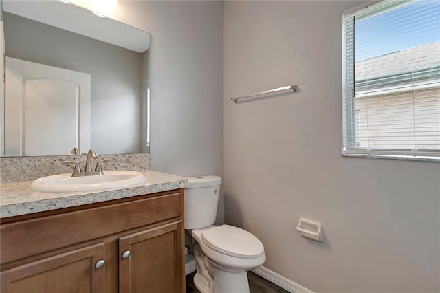 1107 Seminole Sky Dr, Ruskin, FL 33570 - half bathroom featuring toilet, vanity, and baseboards