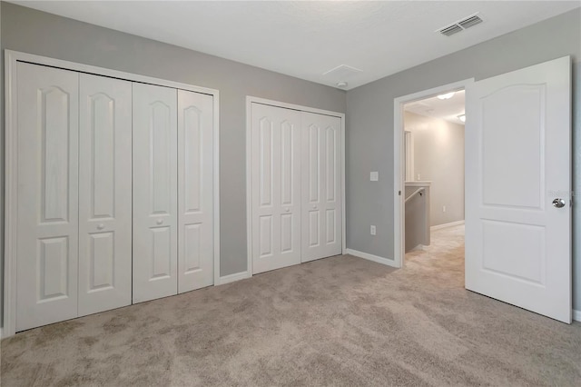 1107 Seminole Sky Dr, Ruskin, FL 33570 - unfurnished bedroom with multiple closets, carpet, and baseboards