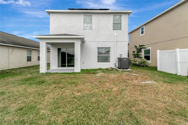 1107 Seminole Sky Dr, Ruskin, FL 33570 - back of house featuring cooling unit, stucco siding, and solar panels