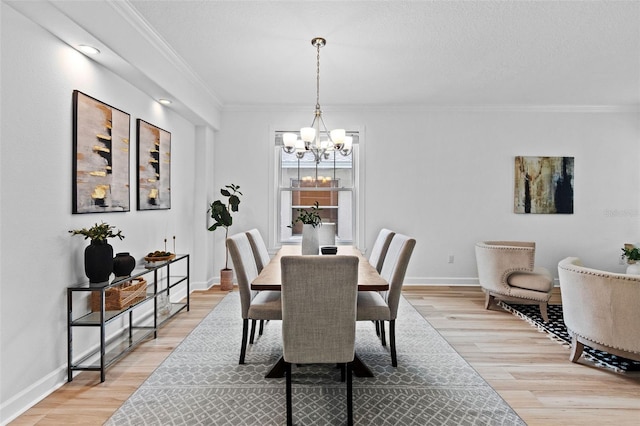 16206 Nottingham Park Way, Tampa, FL 33647 - dining area with a chandelier, light wood finished floors, crown molding, and baseboards
