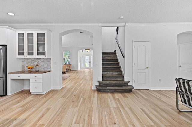 16206 Nottingham Park Way, Tampa, FL 33647 - staircase featuring arched walkways, wood finished floors, crown molding, recessed lighting, and baseboards