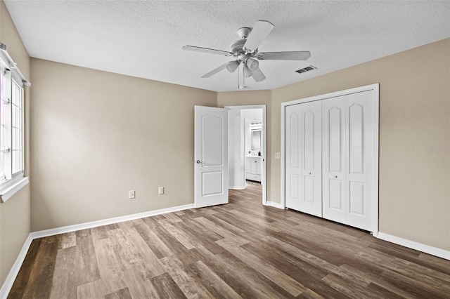 16206 Nottingham Park Way, Tampa, FL 33647 - unfurnished bedroom featuring wood finished floors, baseboards, a closet, a textured ceiling, and ceiling fan