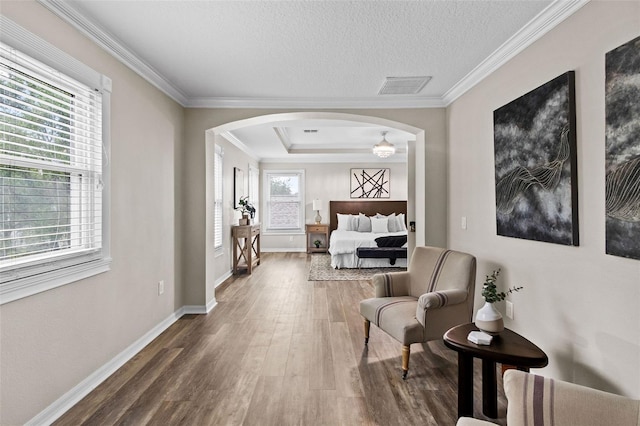 16206 Nottingham Park Way, Tampa, FL 33647 - living area with arched walkways, wood finished floors, baseboards, ornamental molding, and a textured ceiling