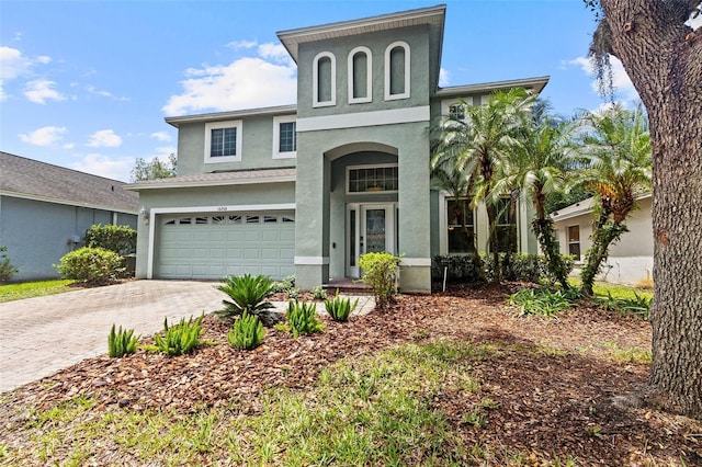 16206 Nottingham Park Way, Tampa, FL 33647 - view of front of house featuring stucco siding, a garage, and decorative driveway